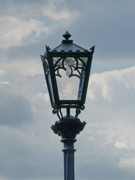 Street lamp on the lamp post against cloudy sky against cloudy blue sky background