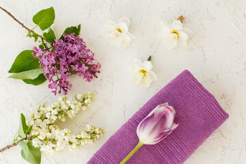 Obraz na płótnie Canvas Towel and flowers on the white background.
