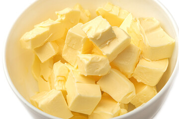 Fresh butter cubes close-up in a white bowl.