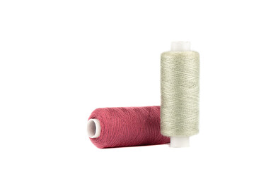 Threads on spools of celeste and rouge colors isolated on white background.