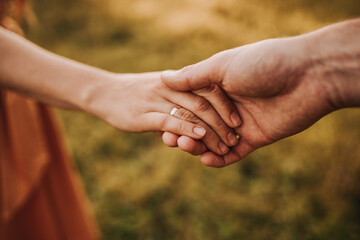 close up of couple holding hands