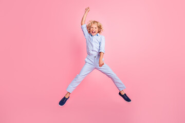 Fototapeta na wymiar Full size photo of funky funny carefree smiling schoolboy jumping fooling around isolated on pink color background