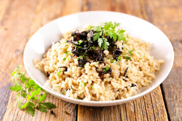 bowl of mushroom risotto and parsley