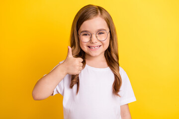 Photo of young little girl happy positive smile show thumb-up like fine recommend ad isolated over...