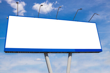 An empty billboard against a blue cloudy sky, mockup