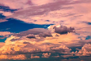 evening cloudy sky with colorful storm clouds approaching in the distance