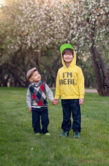 Fototapeta premium Portrait of a two cute stylishly dressed brothers .Outdoor, close up. summer time photo .