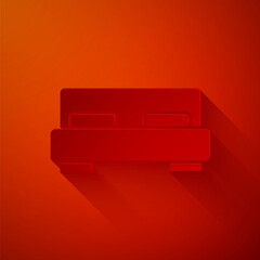 Obraz na płótnie Canvas Paper cut Big bed for two or one person icon isolated on red background. Paper art style. Vector