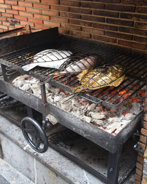 Fresh Turbot (Rodaballo) cooks on a traditional grill in the fishing town of Getaria in the Basque Country, Spain