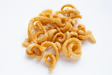 Fried crispy pork rinds on white background.