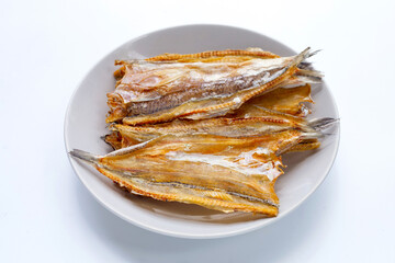 Sun dried black kingfish on white background.