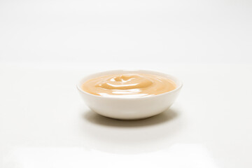 Mushroom sauce in a bowl isolated on white background.