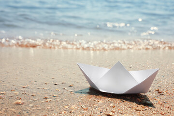 White paper boat near sea on sunny day, space for text