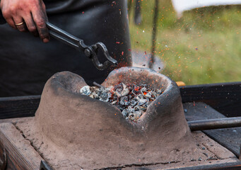 clay hearth with hot coals for heating metal