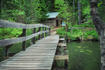Wooden bridge leading to a cabin in the woods
