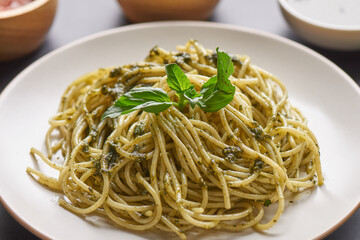 Pasta spaghetti with zucchini, basil, cream and cheese on black stone table. vegetarian vegetable pasta. zucchini noodles. top view copy space. penne pasta with pesto sauce, flat lay.