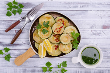 Fried zucchini with green sauce