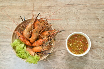 grilled river shrimp arranging with fresh lettuce on bowl dipping spicy sauce