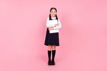 Fototapeta Full length body size photo schoolgirl in uniform embracing laptop smiling isolated pastel pink color background obraz