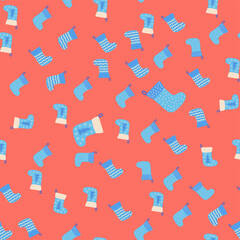 Christmas seamless pattern with red Christmas socks with snowflakes, specks