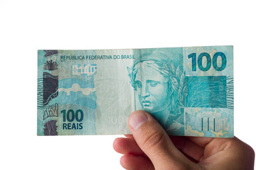 man holding hundred reais bills isolated on white. Brazilian money