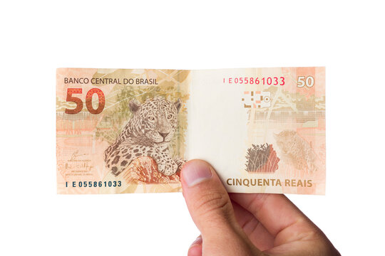 Brazillian Money, man holding 50 Reais notes isolated on white