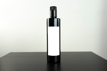 Olive oil round elegant bottle with back white label and withe background all for mockup purposes