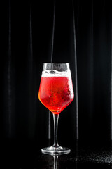 Close up of red champagne glass on a black background. drink, holidays party concept