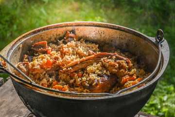 Traditional oriental pilaf in a cauldron