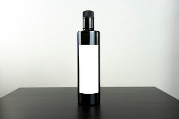 Olive oil round elegant bottle with frontal white label and withe background all for mockup purposes