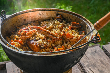Traditional oriental pilaf in a cauldron