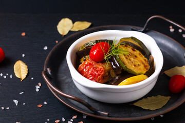 Healthy food concept Homemade Ratatouille in white ceramic cup on black background with copy space
