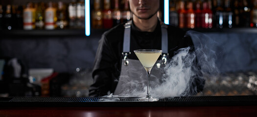 alcoholic cocktail with smoke on the bar table
