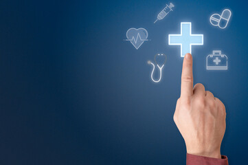 hand points to sign of medical cross. hand pressing medicine sign. man press glowing medical cross sign, insurance in virtual screen. Businessman pressing cross shape icon over blue background
