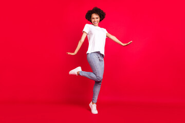 Fototapeta na wymiar Full length body size photo smiling curly woman wearing stylish outfit isolated bright red color background
