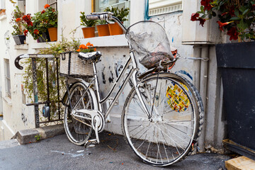 Old bicycle painted white as decoration of the facade of a restaurant