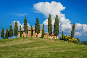 Rural house on the slope with cypresses, Tuscany, Italy
