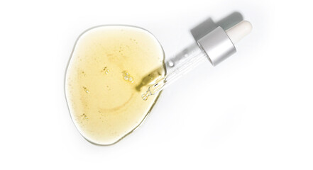 Drops of facial serum with pipette on glass on futuristic gray background. Trendy products of the...