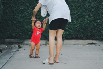 baby step in outdoor to practice balance walk in development according to the age of the child with...