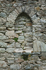 A stone window in a stone wall.