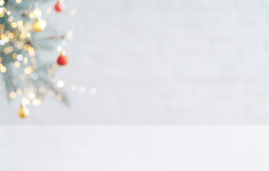White table in against of blurred branch of Christmas tree with bauble