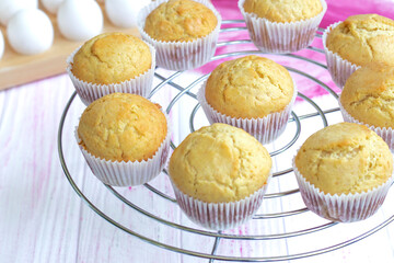 Selective focus. classic homemade muffins are cooled on a wire rack to cool. Fresh vanilla cupcakes close up. Vanilla baked goods. High quality photo