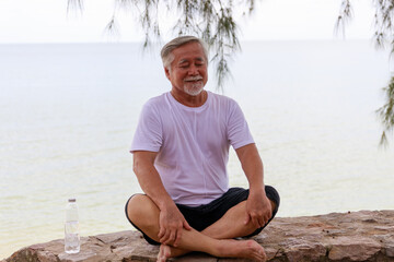 Senior male meditation outdoor.
