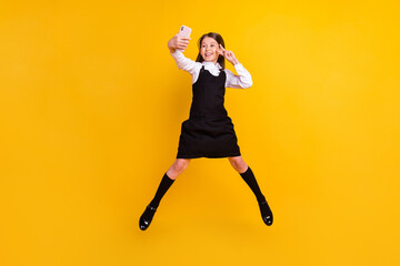 Fototapeta na wymiar Full body photo of brunette little small girl jump up wear uniform formalwear long socks make selfie v-sign jump