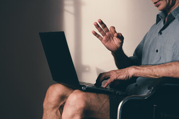Lonely disabled man on wheelchair using technology and social media, Hobbies for people with disabilities to do to improve mental health, Prevent depression and stress that can lead to suicide.
