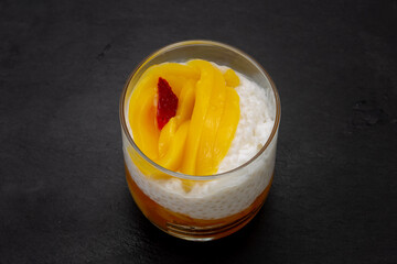 Sweet tapioca pudding with fresh mango and strawberry