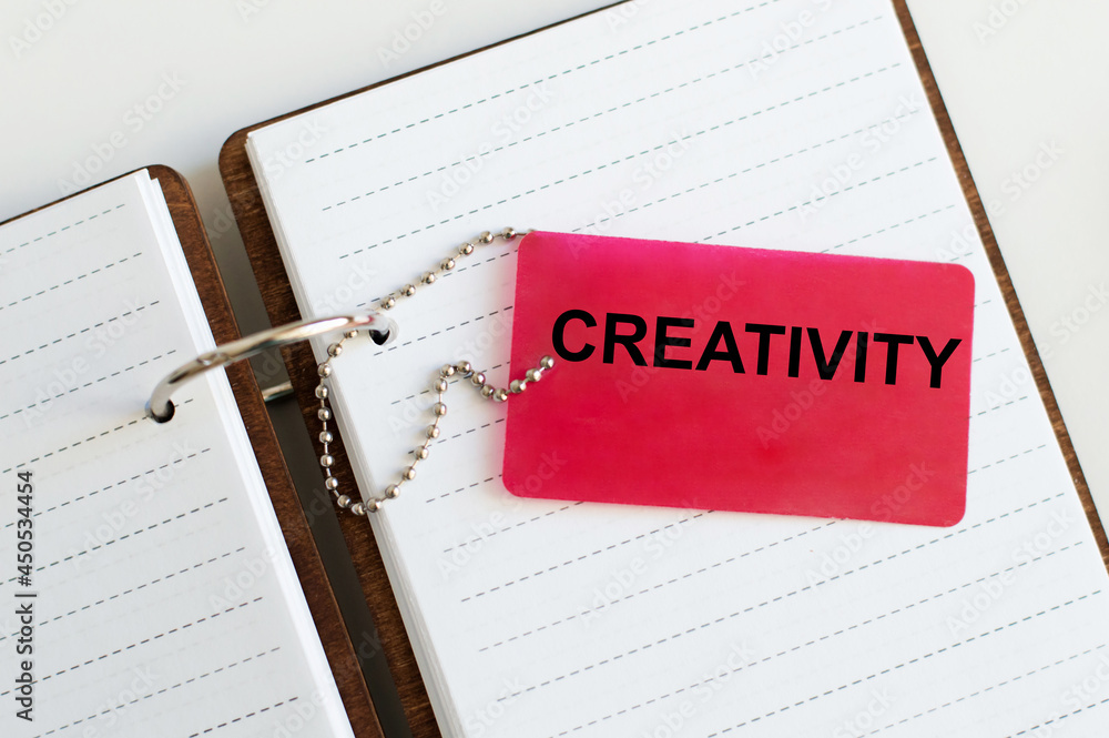Poster notebook with a red tag on which the text creativity