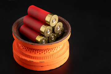 Clay shooting target and shotgun bullets on black background ,Clay Pigeon target game