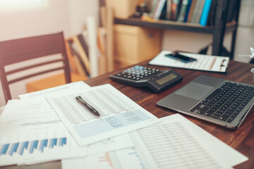 Pen on data sheet on the office desk. Calculator with accounting report and financial statement on desk.