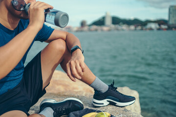 sport man checking at smartwatch during training and running in the park.